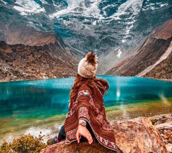 Postcard view of the bright turquoise Humantay Lake nestled under the massive Humantay glacier mountain