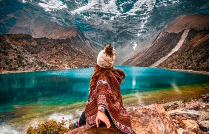 Postcard view of the bright turquoise Humantay Lake nestled under the massive Humantay glacier mountain