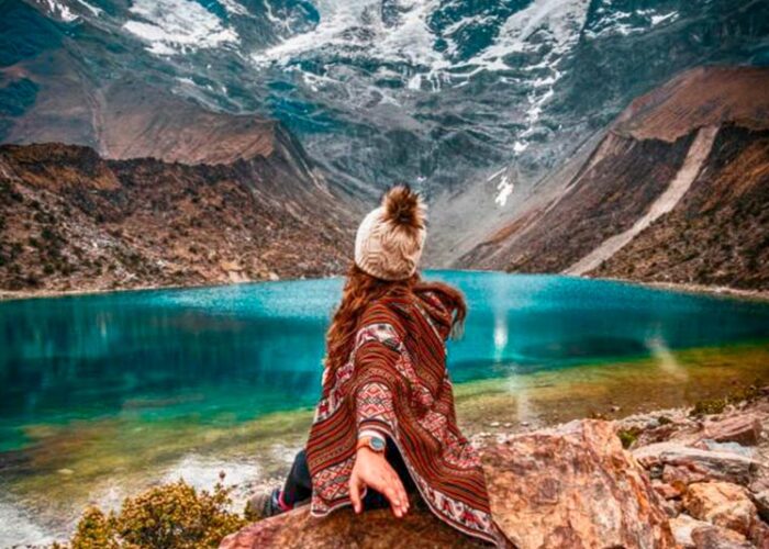 Postcard view of the bright turquoise Humantay Lake nestled under the massive Humantay glacier mountain