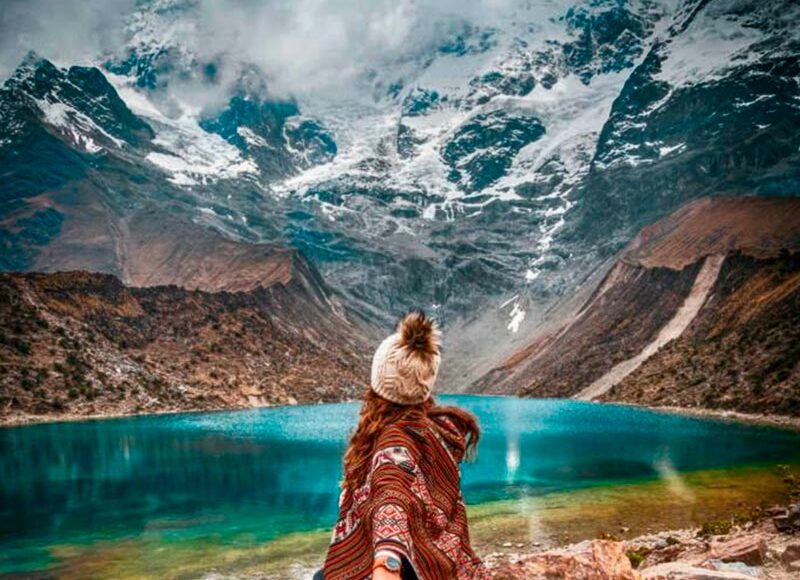 Postcard view of the bright turquoise Humantay Lake nestled under the massive Humantay glacier mountain
