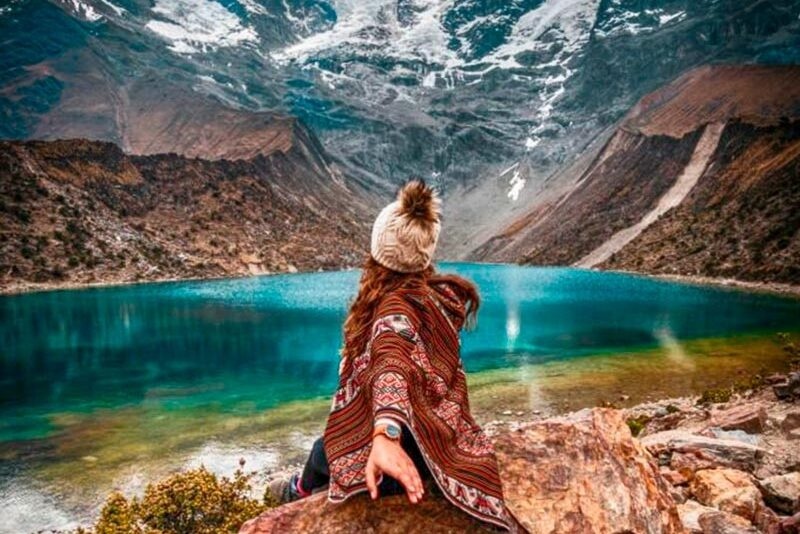 Postcard view of the bright turquoise Humantay Lake nestled under the massive Humantay glacier mountain