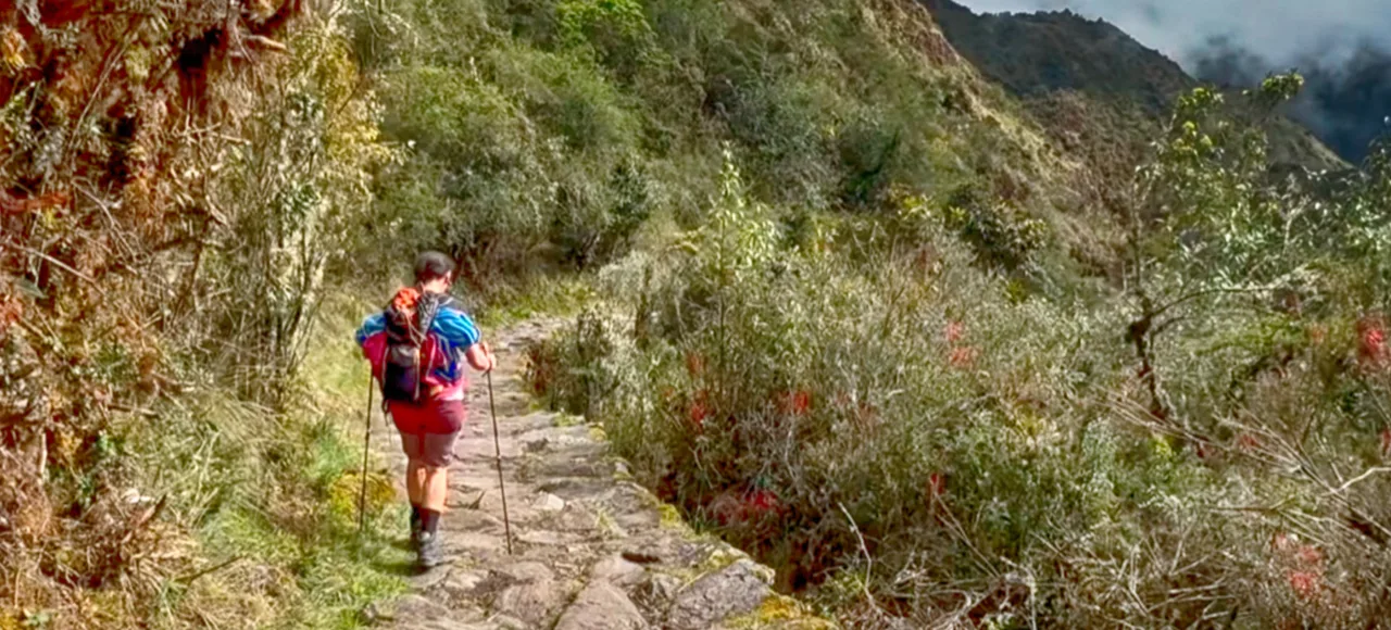 Tourists exploring the ancient stone terraces of Chachabamba ruins on the Short Inca Trail 2 Days