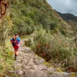 Tourists exploring the ancient stone terraces of Chachabamba ruins on the Short Inca Trail 2 Days