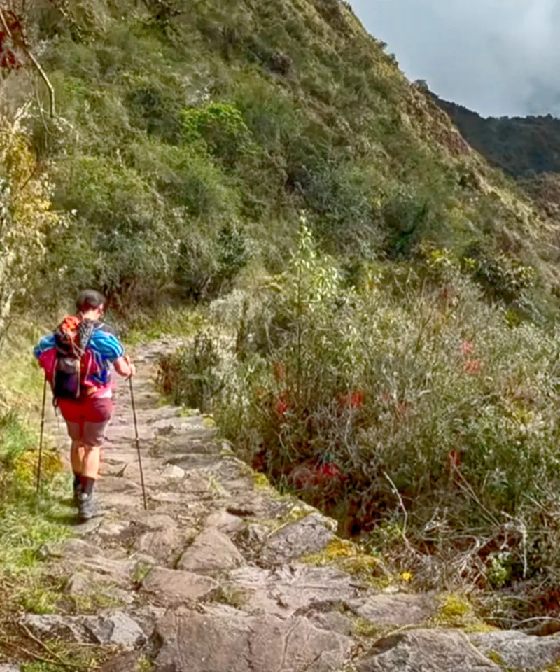 Tourists exploring the ancient stone terraces of Chachabamba ruins on the Short Inca Trail 2 Days